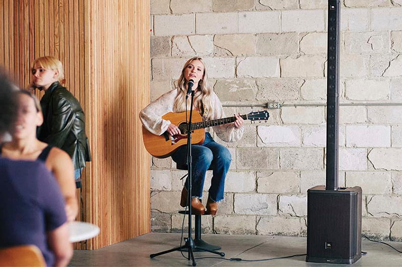 Escenario con cantante usando una JBL PRX One